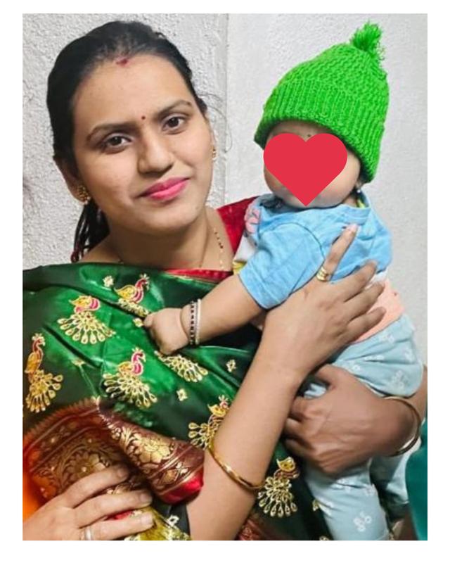 Flow 108 client holding her baby in a green cap